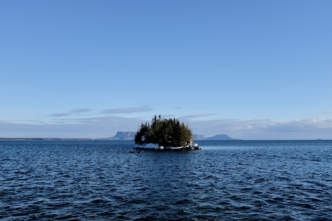 Scenic view of Lake Superior island near Thunder Bay Ontario with green trees and calm water