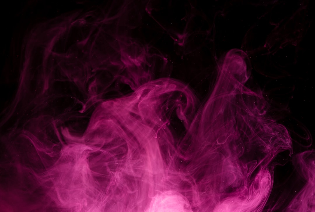 Pink and purple smoke swirling against a dark background evoking the Pink Gasoline cannabis strain