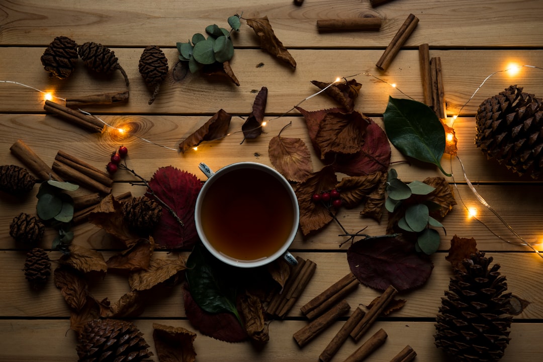 Cozy evening setting with herbal tea and warm lighting perfect for enjoying cannabis edibles