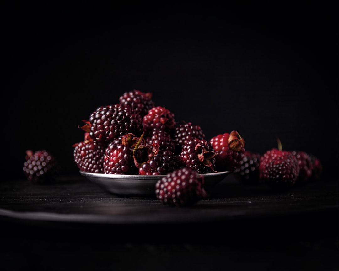A bowl filled with ripe dark blackberries representing the berry flavour of Blackberry Cream cannabis