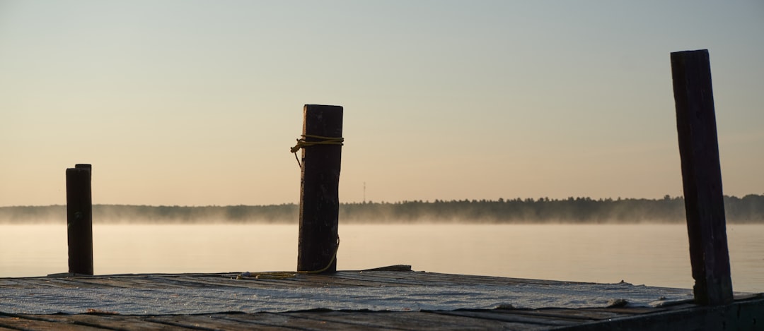 Wooden dock on a calm lake in the Kawartha Lakes region near Peterborough Ontario
