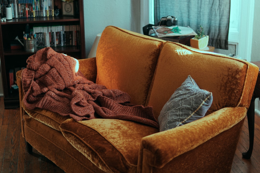 Warm cozy sofa with knit blanket and pillow perfect for a relaxing evening at home