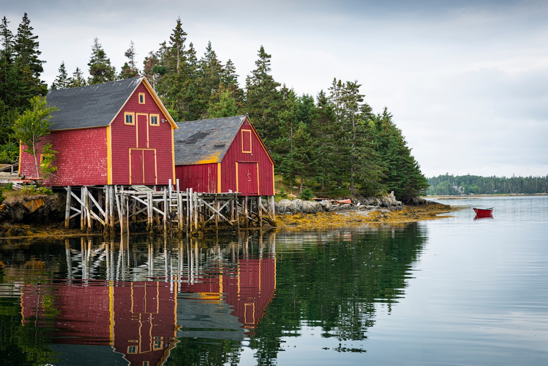 Nova Scotia coastal scenery with red houses beside the water representing Dartmouth cannabis delivery