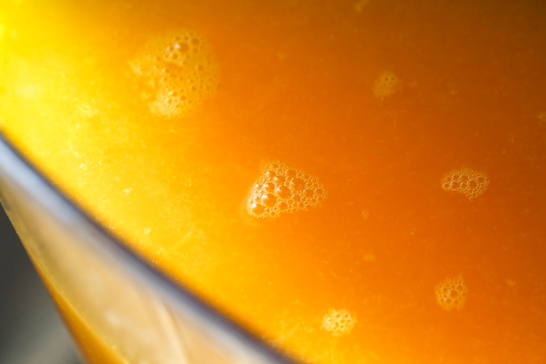 Close-up of golden amber liquid with tiny bubbles evoking live rosin cannabis concentrate
