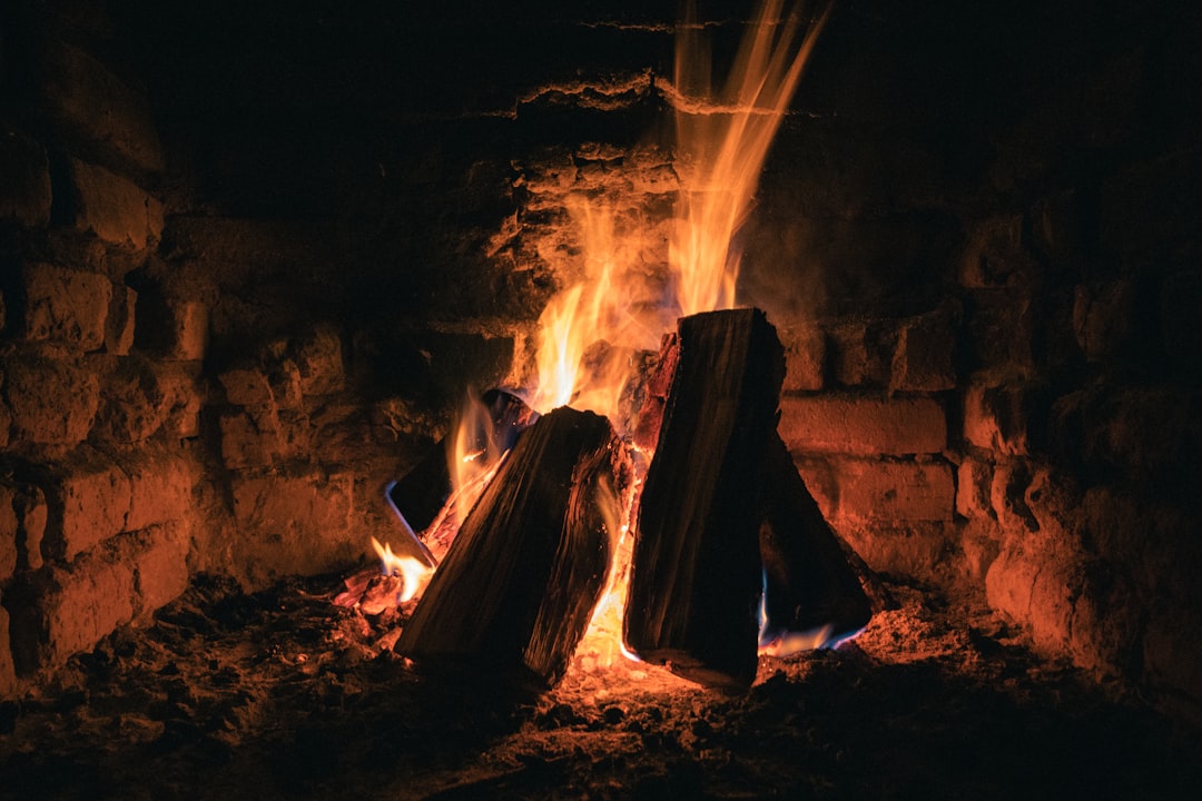Warm fire burning in a brick fireplace creating a cozy evening atmosphere perfect for relaxation