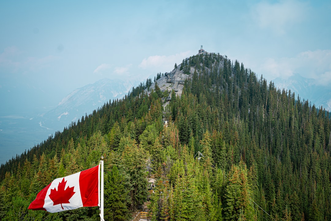 Canadian flag on mountain peak representing Elephant Garden Vancouver BC business