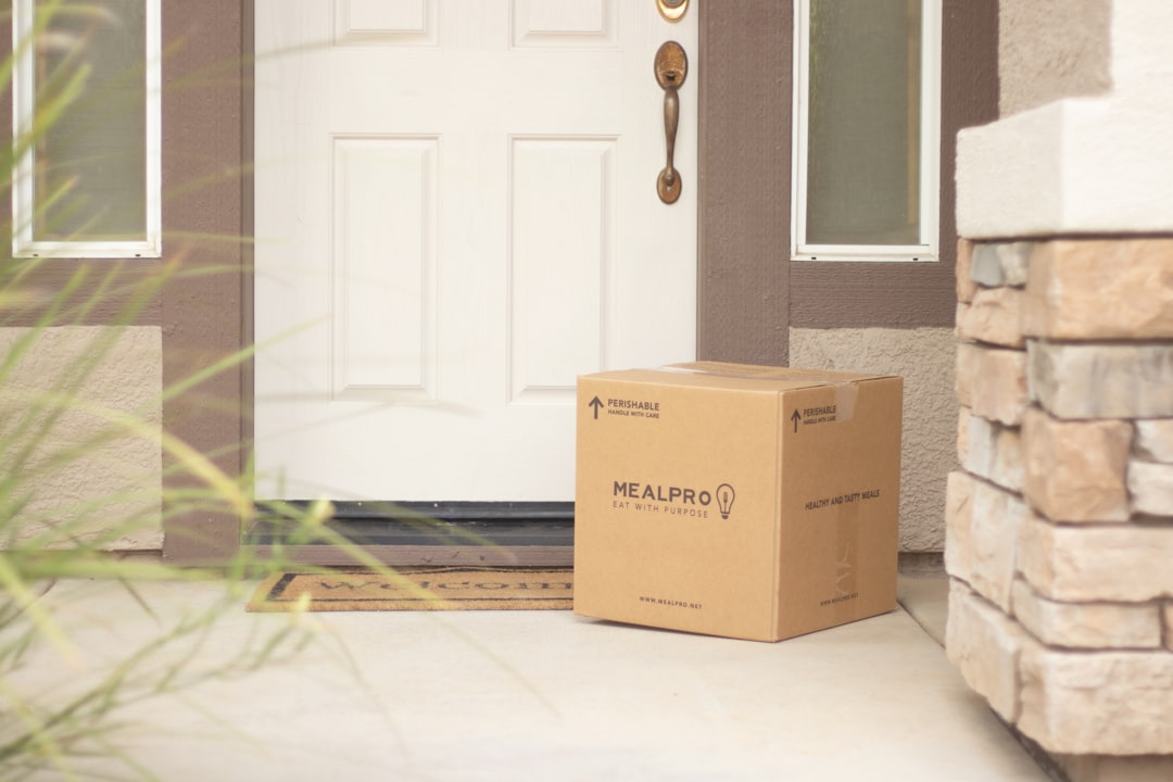 Brown cardboard delivery package at front door of residential home