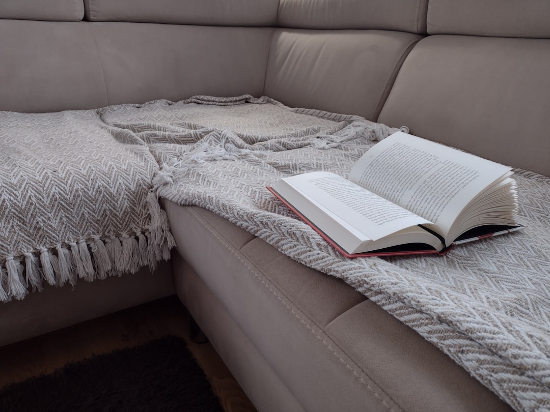 Open book resting on a cozy couch for a relaxing evening at home